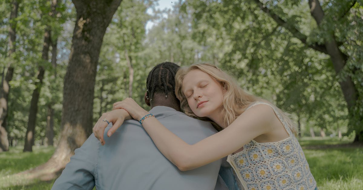 Crossing the border from Switzerland to France and back - Woman Hugging a Man in the Park Crossing the border from Switzerland to France and back - Woman Hugging a Man in the Park