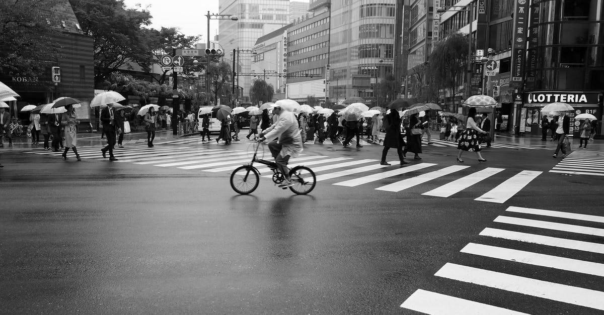 Crossing the Canadian border with all your camping/mountaineering/mountain biking gear? - Grayscale Photo of People Crossing the Street on a Rainy Day Crossing the Canadian border with all your camping/mountaineering/mountain biking gear? - Grayscale Photo of People Crossing the Street on a Rainy Day