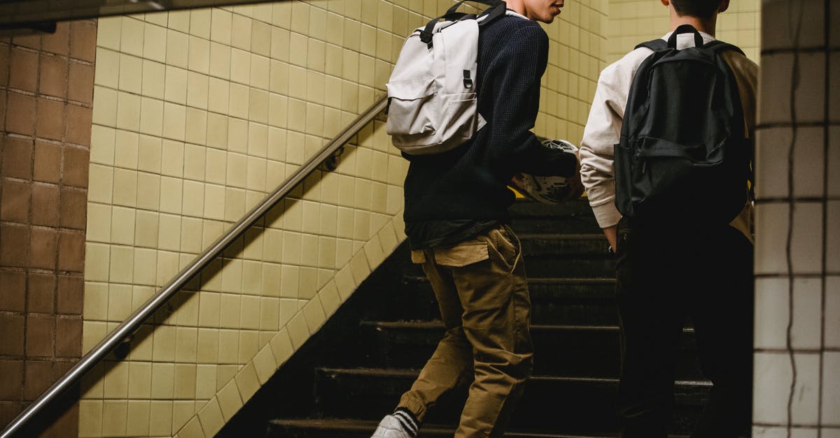 Crossing the US-Canadian border and back - Crop male friends going upstairs in underground passage Crossing the US-Canadian border and back - Crop male friends going upstairs in underground passage