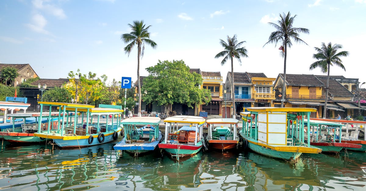 Cruising to Vietnam - Cruise boats moored on river in tropical village Cruising to Vietnam - Cruise boats moored on river in tropical village