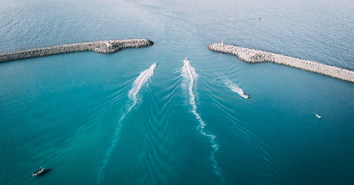 cruising with a Schengen visa from a British port - Ships sailing through sea and leaving ships wakes between breakwaters