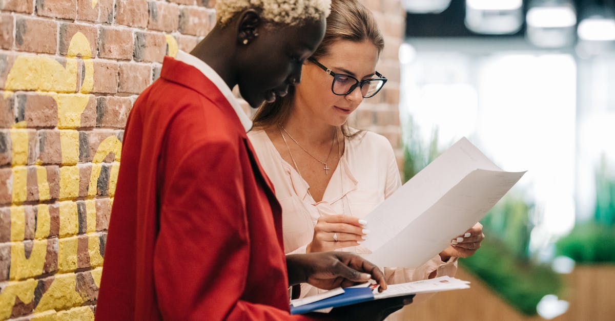 Dealing with bully/rogue consular official - Diverse businesswomen discussing contract on paper Dealing with bully/rogue consular official - Diverse businesswomen discussing contract on paper
