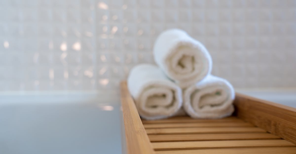 Dial knob in hotel bathroom - Three Towels on Brown Wooden Rack Dial knob in hotel bathroom - Three Towels on Brown Wooden Rack