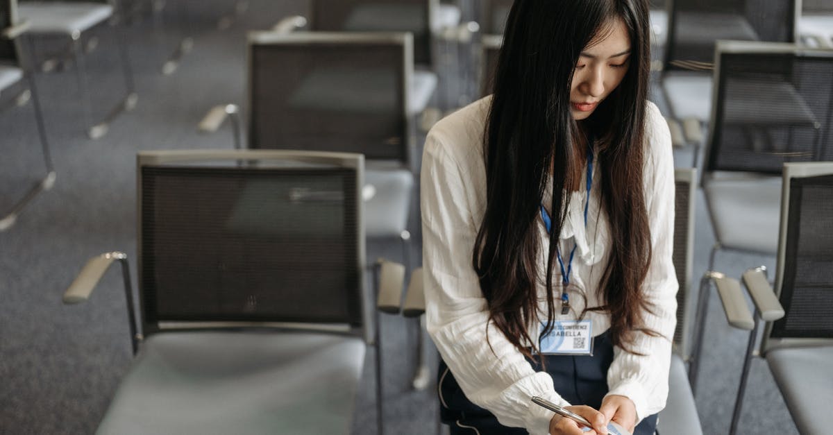 Didn't write down my DS-16 application ID - A Woman Writing on Notepad while inside a Conference Room
