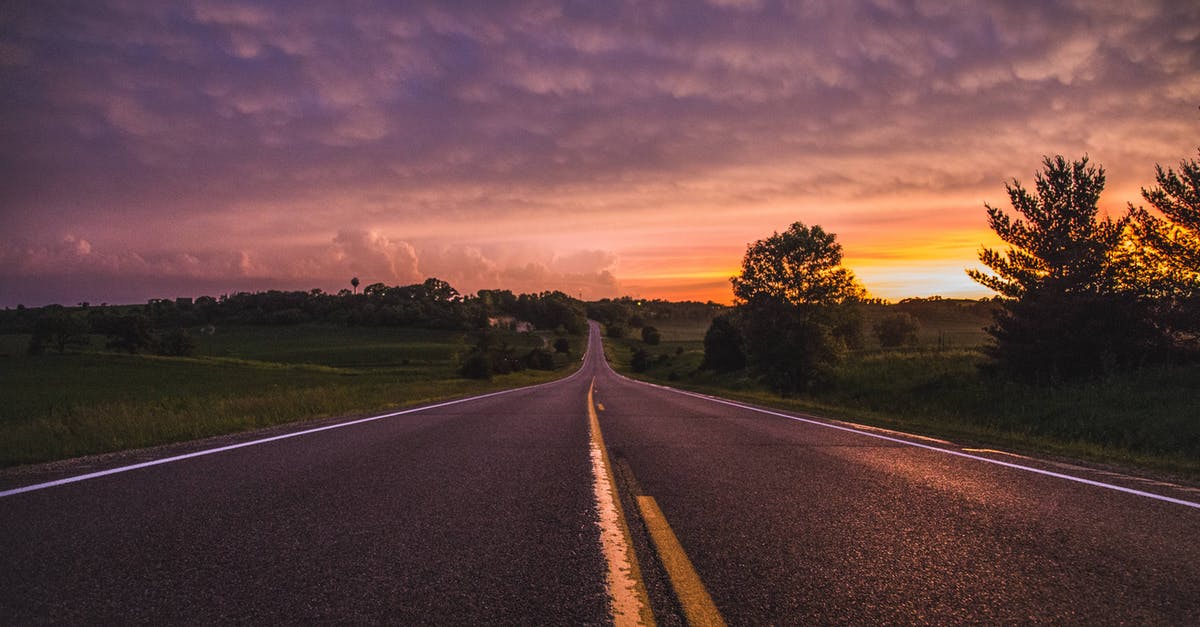 Distance and hours between Phnom Penh and Tay Ninh - Photo of Empty Road In Between Grass Field During Golden Hour