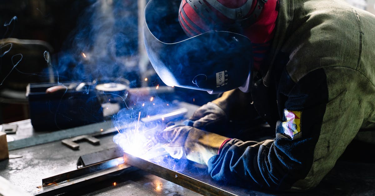 Do airport metal scanners occasionally flash a false alarm on purpose? - Man Welding Metal Bars