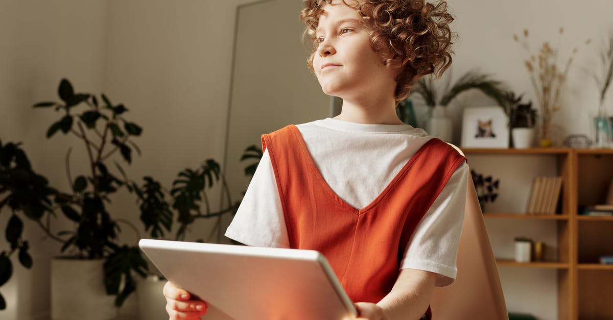 Do children stay free in hotels/accommodation in South Africa? - Photo of Child Sitting on Chair While Holding Tablet Do children stay free in hotels/accommodation in South Africa? - Photo of Child Sitting on Chair While Holding Tablet