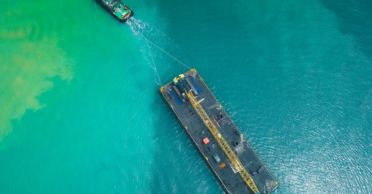 Do cruise passengers answer In Transit on the ESTA application? - Aerial view of modern powerful motorboat floating on azure seawater and transporting big platform with crane Do cruise passengers answer In Transit on the ESTA application? - Aerial view of modern powerful motorboat floating on azure seawater and transporting big platform with crane