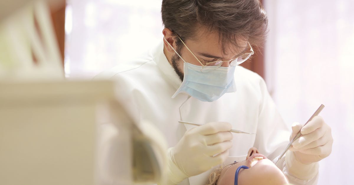 Do doctors outside of US routinely shake hands with their patients and staff? [closed] - Man in White Dress Shirt Wearing White Framed Eyeglasses