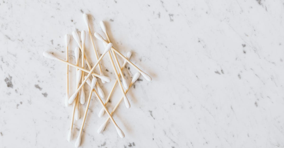 Do ear wax cleaning salons provide related, similar services? - From above of heap of similar cotton swabs on thin wooden sticks with soft edges on marble surface with grey lines Do ear wax cleaning salons provide related, similar services? - From above of heap of similar cotton swabs on thin wooden sticks with soft edges on marble surface with grey lines