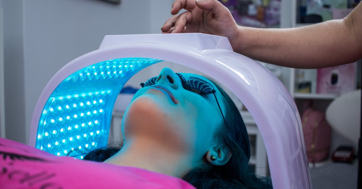 Do ear wax cleaning salons provide related, similar services? - Unrecognizable woman with dark hair with pierced ears lying under ultraviolet lamp while visiting contemporary clinic and spending time in modern salon Do ear wax cleaning salons provide related, similar services? - Unrecognizable woman with dark hair with pierced ears lying under ultraviolet lamp while visiting contemporary clinic and spending time in modern salon