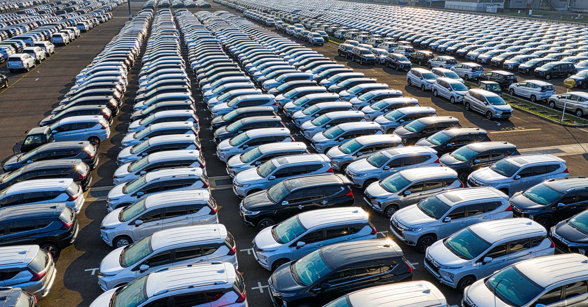 Do ear wax cleaning salons provide related, similar services? - Rows of expensive modern cars on asphalt parking of manufacture Do ear wax cleaning salons provide related, similar services? - Rows of expensive modern cars on asphalt parking of manufacture