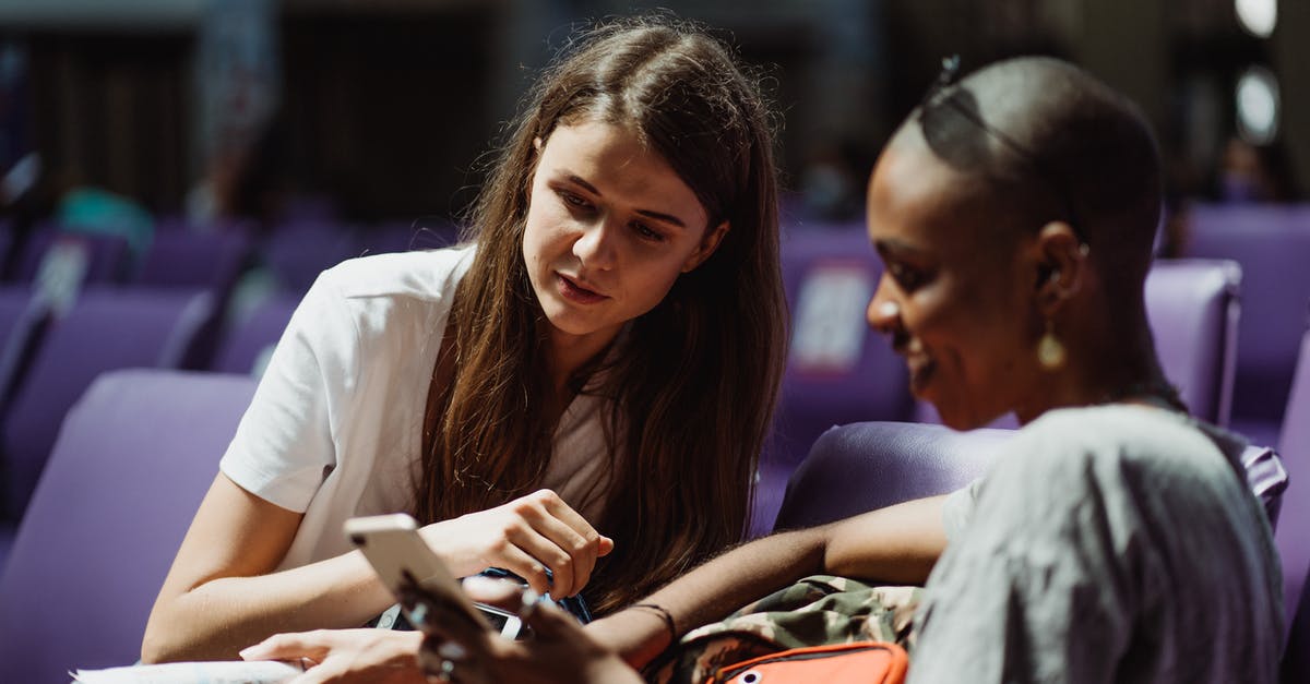 Do EU citizens need travel insurance when visiting Israel? - Woman in White Long Sleeve Shirt Holding Smartphone Do EU citizens need travel insurance when visiting Israel? - Woman in White Long Sleeve Shirt Holding Smartphone