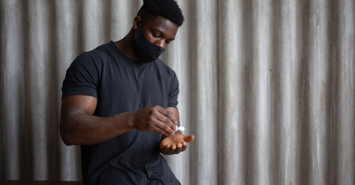 Do EU Refund rules apply to Coronavirus related cancellations by airlines? - Black male athlete in sports clothes and textile mask applying antiseptic gel on hand against ribbed gray wall Do EU Refund rules apply to Coronavirus related cancellations by airlines? - Black male athlete in sports clothes and textile mask applying antiseptic gel on hand against ribbed gray wall