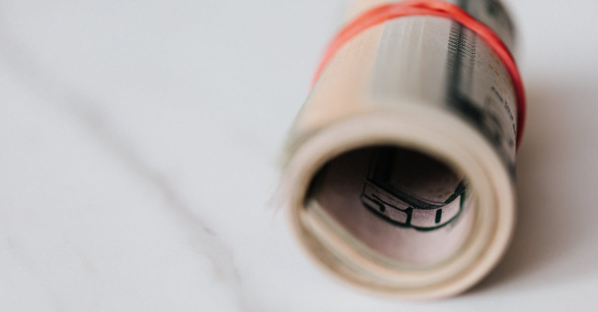 Do Europe's ATMs offer good US$ → € exchange rates? [closed] - American dollar banknotes rolled and tightened with red band