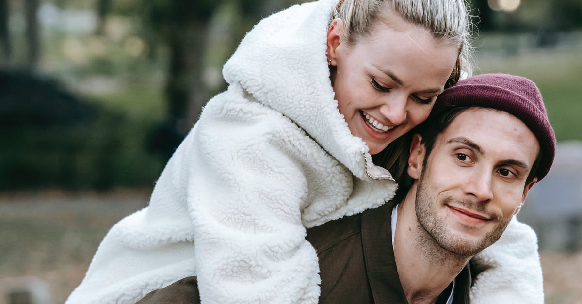 Do foreign students always have to carry their passports with them? [closed] - Smiling man giving piggyback ride to beloved woman in park