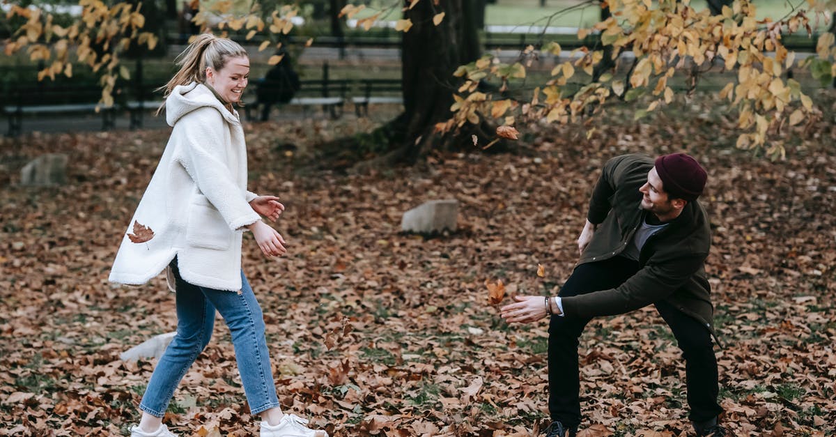 Do H dependent visa holders have due date that they have to enter the USA? [closed] - Cheerful young couple playing with fallen leaves in park