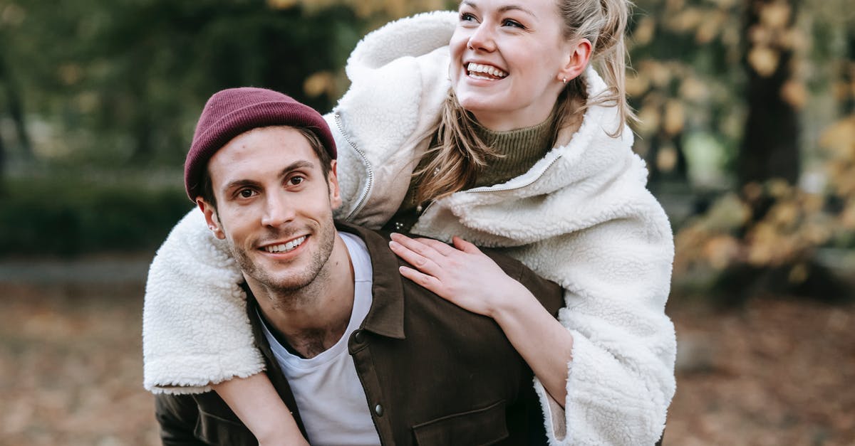 Do H dependent visa holders have due date that they have to enter the USA? [closed] - Cheerful young couple hugging and having fun in autumn garden