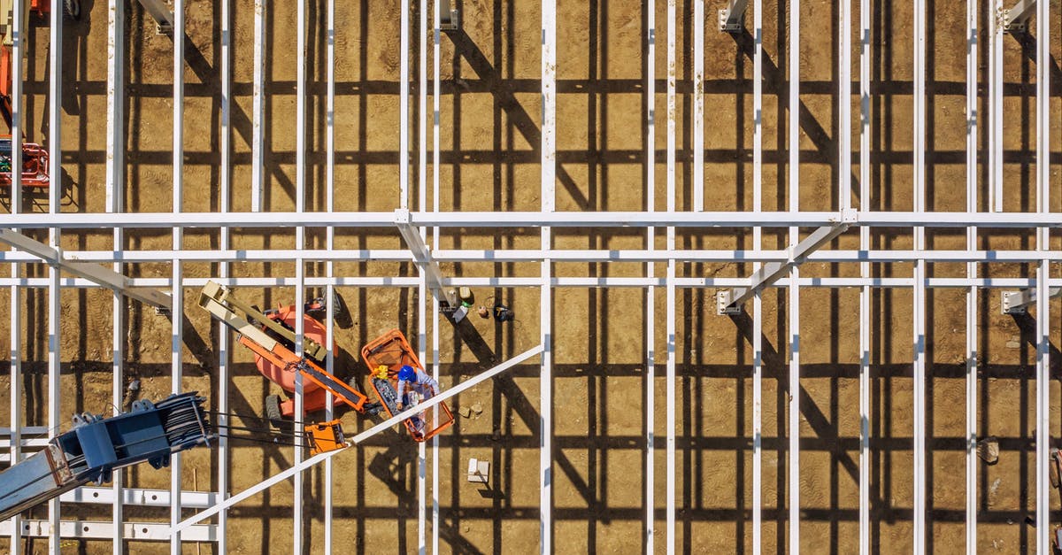 Do hostels provide toiletries? - Top view of mechanical machines providing frame of future building in sandy quarry on sunny day Do hostels provide toiletries? - Top view of mechanical machines providing frame of future building in sandy quarry on sunny day
