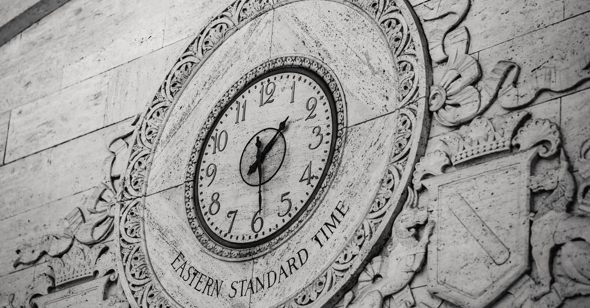 Do Hotel receipts in England show number of guests? - From below black and white of stone wall with ornamental details around clock showing Eastern Standard Time Do Hotel receipts in England show number of guests? - From below black and white of stone wall with ornamental details around clock showing Eastern Standard Time