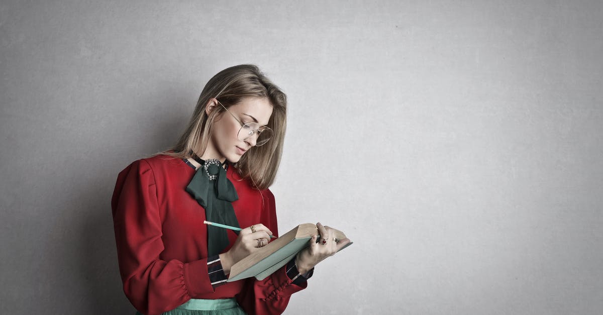 Do I have to inform the hotel about my lateness for check in? [duplicate] - Pensive attentive woman in glasses and elegant vintage outfit focusing and taking notes with pencil in book while standing against gray wall