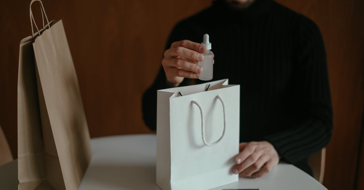 Do I have to pay double for checked baggage? - Focused man pulling out beauty product from shopping bag at table Do I have to pay double for checked baggage? - Focused man pulling out beauty product from shopping bag at table