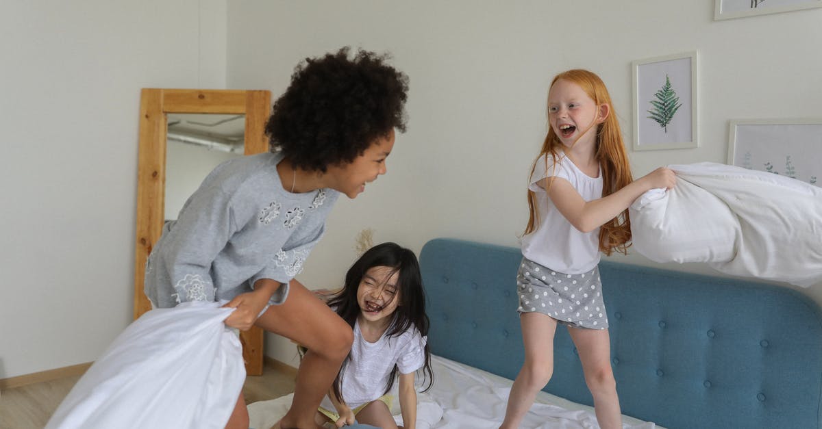 Do I have to pay if I break something in an Airbnb room in case the host doesn't set the security deposit? - Cheerful girls fighting with pillows on bed Do I have to pay if I break something in an Airbnb room in case the host doesn't set the security deposit? - Cheerful girls fighting with pillows on bed