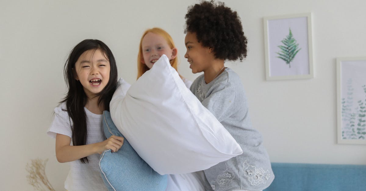 Do I have to pay if I break something in an Airbnb room in case the host doesn't set the security deposit? - Happy diverse children having pillow fight while laughing cheerfully on bed in daytime Do I have to pay if I break something in an Airbnb room in case the host doesn't set the security deposit? - Happy diverse children having pillow fight while laughing cheerfully on bed in daytime