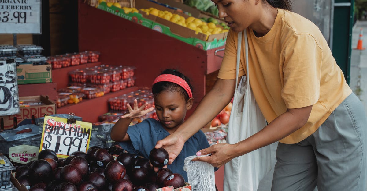 Do I have to pick up my luggage at Seoul Incheon and how many bags am I able to check? - Asian woman putting black plum into eco bag while choosing fruits from box in street market with daughter Do I have to pick up my luggage at Seoul Incheon and how many bags am I able to check? - Asian woman putting black plum into eco bag while choosing fruits from box in street market with daughter