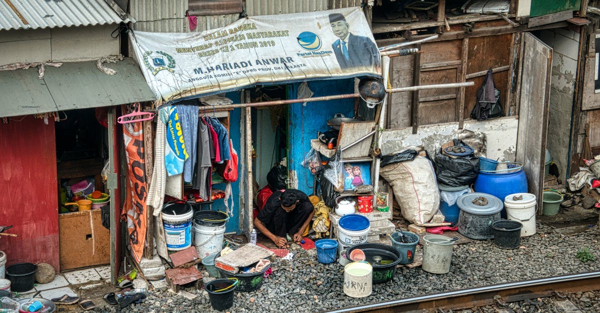 Do I need a passport to return from Canada? - Unrecognizable man working on street near railway