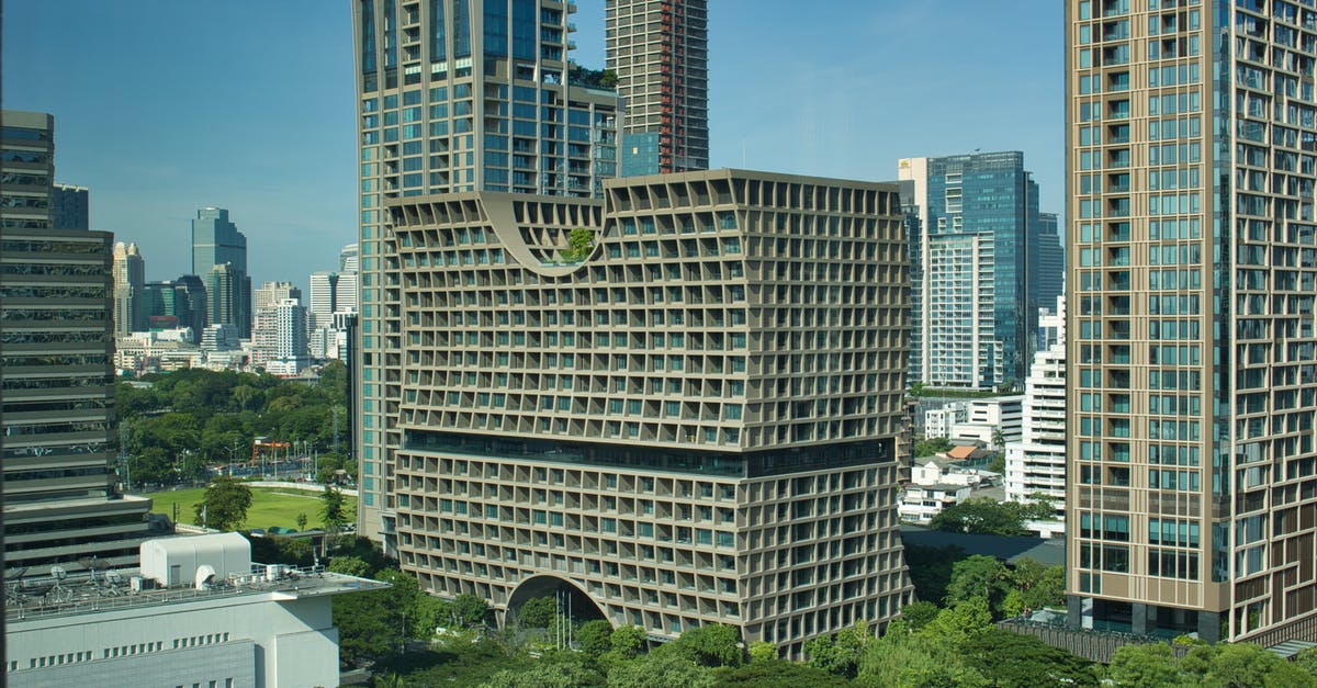 Do I need a Thailand Transit Visa if going from India to Vietnam via BKK where the layover is 9 hours approx ? I am travelling by Thai Airways [duplicate] - White Concrete Building Near Green Trees