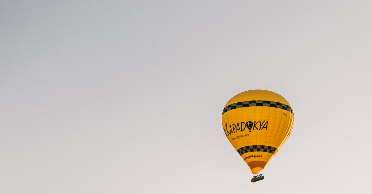 Do I need a transit visa for Turkey if I have an onwards flight from IST - From below of bright yellow hot air balloon flying in cloudless blue sky in Cappadocia in daytime Do I need a transit visa for Turkey if I have an onwards flight from IST - From below of bright yellow hot air balloon flying in cloudless blue sky in Cappadocia in daytime
