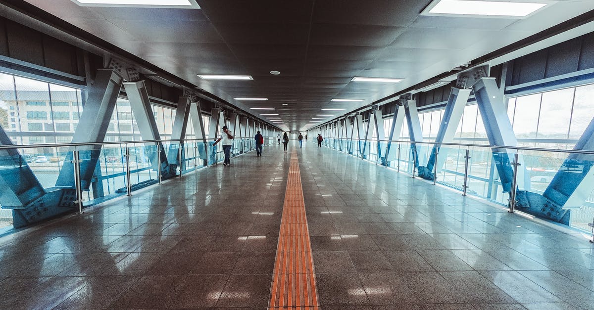 Do I need a transit Visa, if my layover at LHR airport is of 20 hours extending on to the next day [duplicate] - People Walking Inside Tunnel