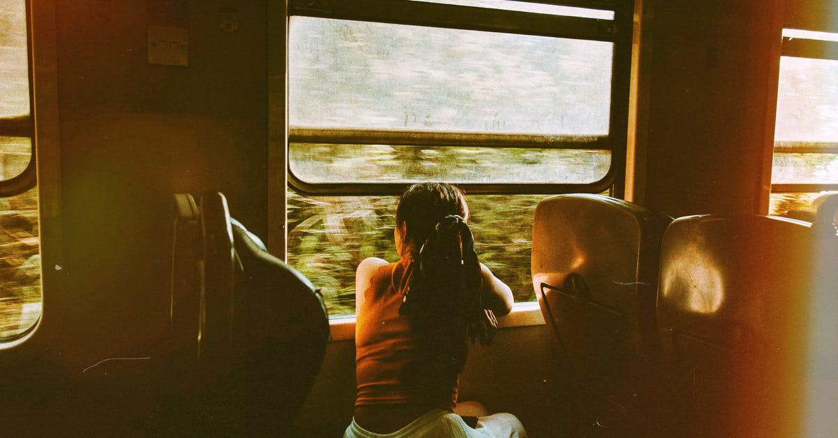 Do I need a vehicle rental to explore Miami FL? - Unrecognizable woman riding train and looking out window Do I need a vehicle rental to explore Miami FL? - Unrecognizable woman riding train and looking out window