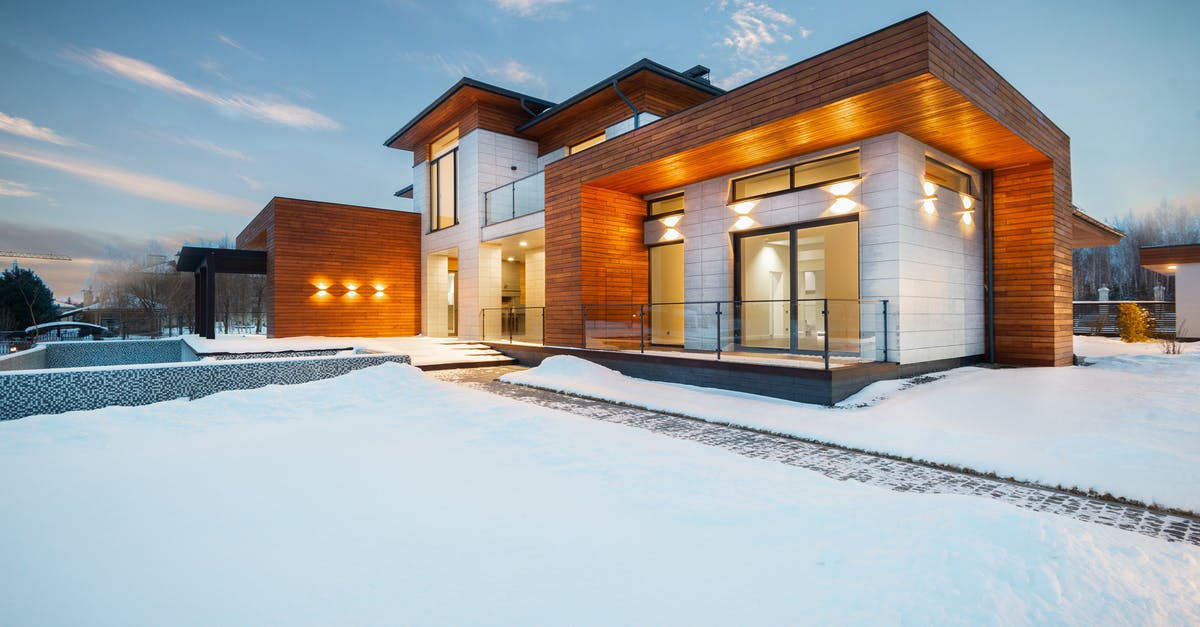 Do I need a visa in New Delhi? - Exterior architecture of private suburban cottage house with stone and wooden facade and large windows overlooking spacious snow covered yard in winter day Do I need a visa in New Delhi? - Exterior architecture of private suburban cottage house with stone and wooden facade and large windows overlooking spacious snow covered yard in winter day