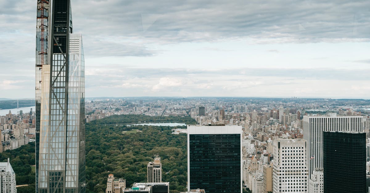 Do I need a visa to go to Canada from America if I have a Green Card? - Modern skyscrapers against cloudy sky Do I need a visa to go to Canada from America if I have a Green Card? - Modern skyscrapers against cloudy sky