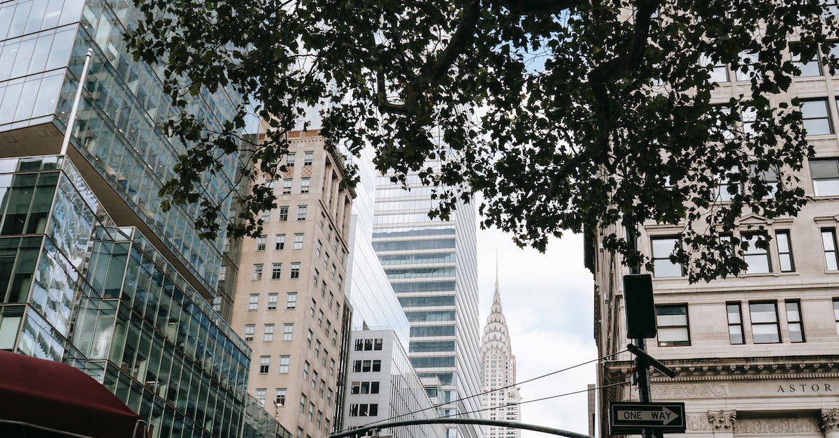 Do I need a visa to go to Canada from America if I have a Green Card? - Modern city street with skyscrapers Do I need a visa to go to Canada from America if I have a Green Card? - Modern city street with skyscrapers