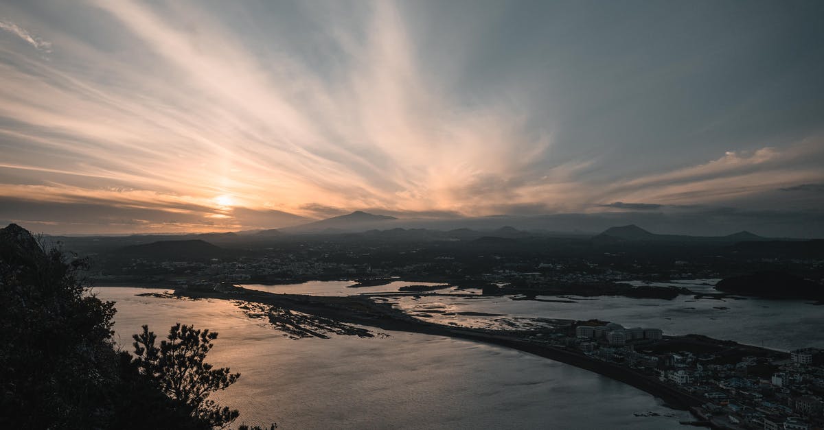 Do I need a visa to transit through South Korea? - Body of Water Near Trees during Sunset Do I need a visa to transit through South Korea? - Body of Water Near Trees during Sunset