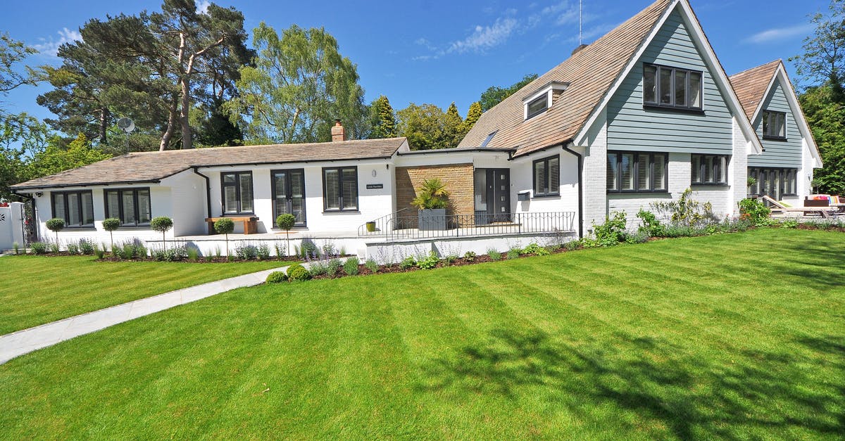 Do I need a visa to visit the UK with my EU family members if I have a Spanish residence card? - White Wooden 2-storey House Near Tree