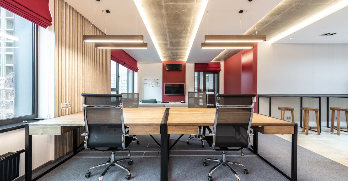 Do I need a visa to work for my company in Europe whilst holidaying in New Zealand? [duplicate] - Office interior with table and chairs near window