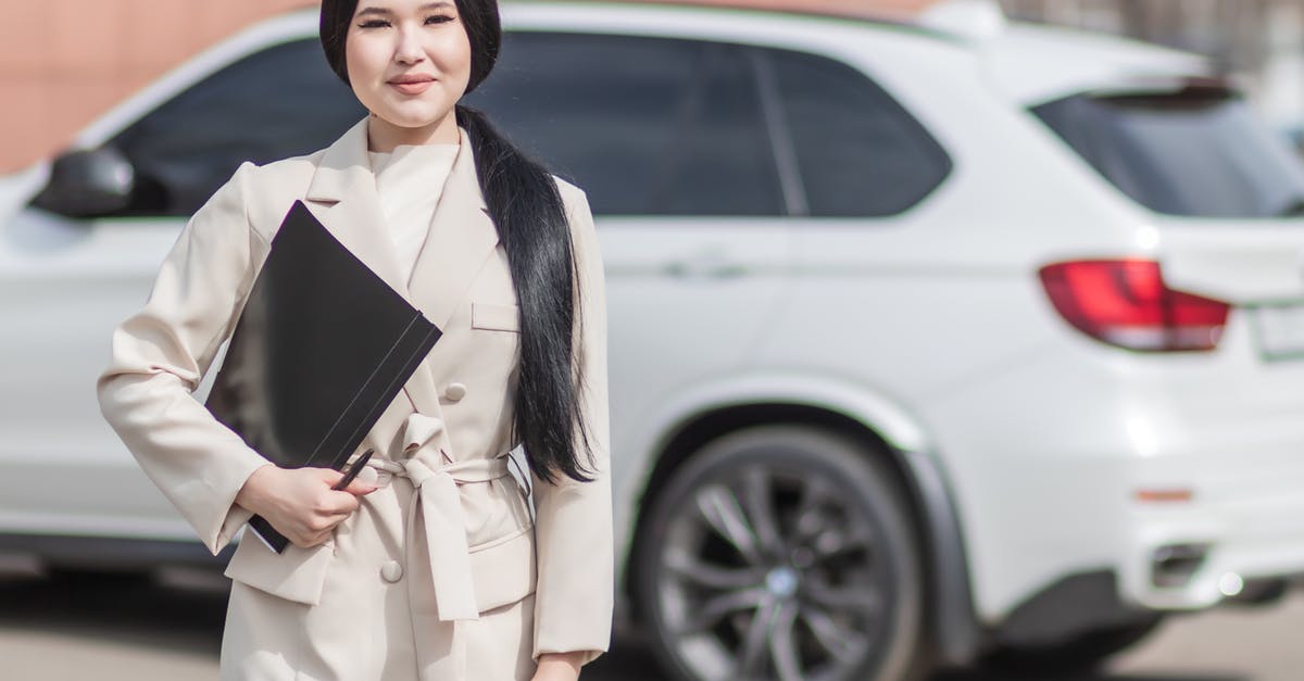 Do I need any additional insurance from the car rental? - Woman in Beige Corporate Clothes Holding Black Folder Do I need any additional insurance from the car rental? - Woman in Beige Corporate Clothes Holding Black Folder