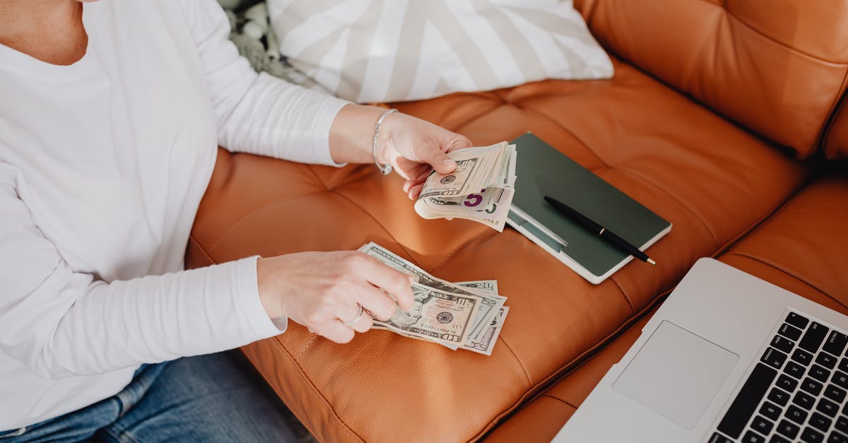Do I need cash CHF for a weekend in Zurich? - Woman Sitting and Counting Money in front of a Laptop Do I need cash CHF for a weekend in Zurich? - Woman Sitting and Counting Money in front of a Laptop