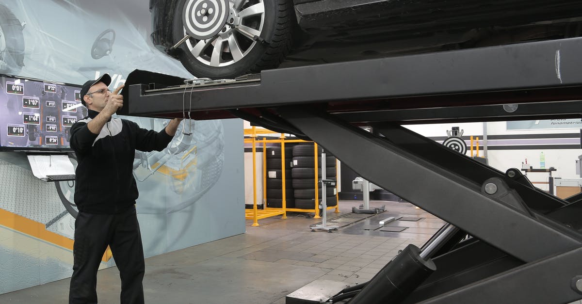 Do I need PCR test to enter Switzerland by vehicle from Germany? - Serious mechanic checking car wheels on lift in modern car service garage Do I need PCR test to enter Switzerland by vehicle from Germany? - Serious mechanic checking car wheels on lift in modern car service garage