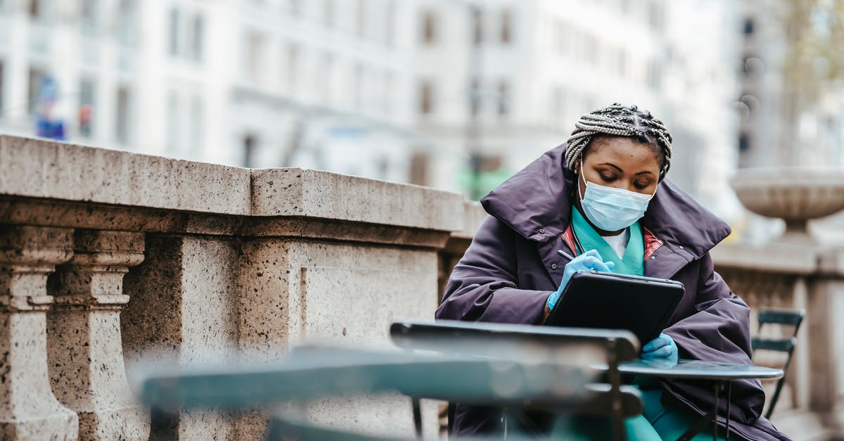 Do I need proof of prescriptions to take controlled medicines, like Vicodin or Valium? - Focused African American woman in protective mask and gloves sitting at table and writing information in balcony