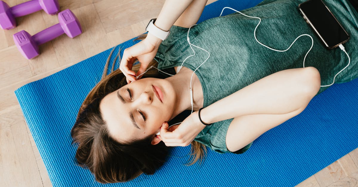Do I need sponsorship from an employer to get a Tier 5 (Youth Mobility Scheme) visa for the UK (from CAD)? [closed] - Sportive lady in earphones listening to music chilling on mat