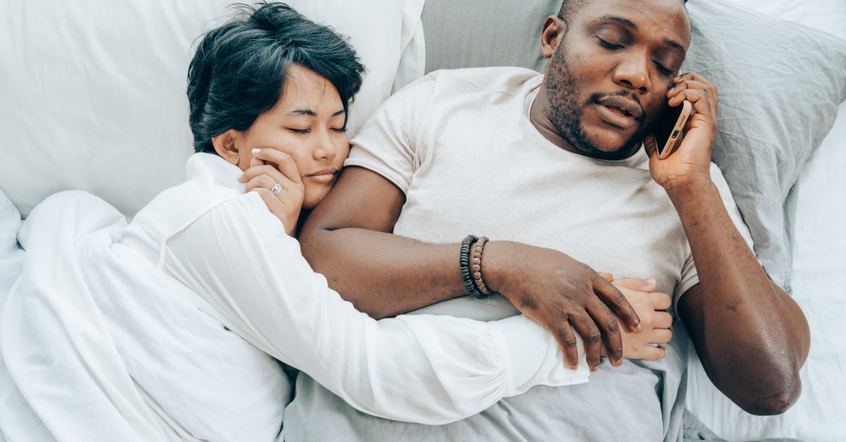 Do I need sponsorship from an employer to get a Tier 5 (Youth Mobility Scheme) visa for the UK (from CAD)? [closed] - From above of young African American man with closed eyes talking on smartphone lying in bed together with sleeping ethnic wife