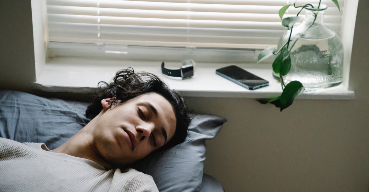Do I need sponsorship from an employer to get a Tier 5 (Youth Mobility Scheme) visa for the UK (from CAD)? [closed] - High angle of young ethnic male sleeping in bed with smartphone and smart watch placed near head on windowsill
