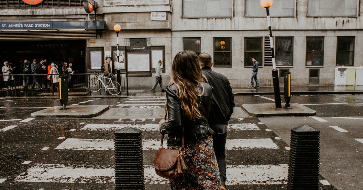 Do I need to have travel insurance when crossing Schengen border? - Couple Crossing The Street Do I need to have travel insurance when crossing Schengen border? - Couple Crossing The Street