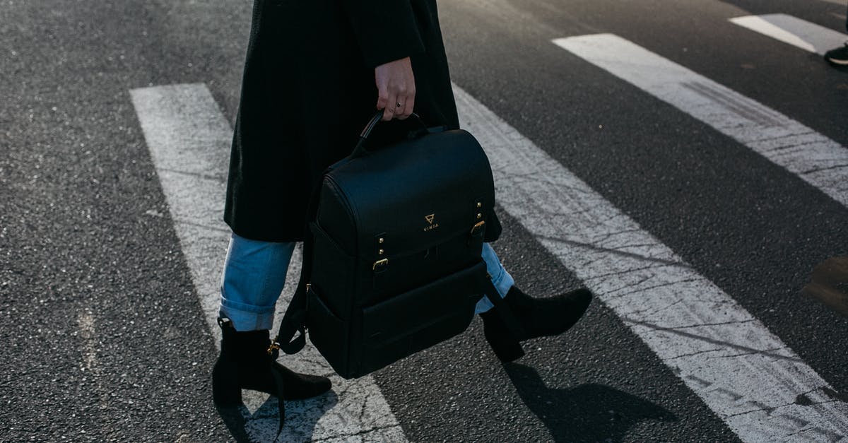 Do I need to have travel insurance when crossing Schengen border? - Person Carrying Bag Walking on Pedestrian Lane Do I need to have travel insurance when crossing Schengen border? - Person Carrying Bag Walking on Pedestrian Lane