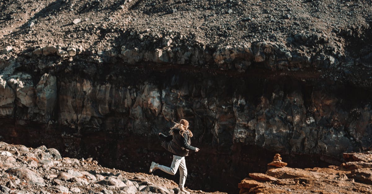 Do I need to include details about a side trip to another country on my Schengen application form? - Side view of lonely female with long hair running on empty ground of rocky formation in sunlight
